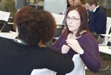 BAVC Media Apprenticeships Two seated women deep in conversation at an event.