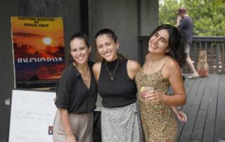 3 women smile at fundraising event