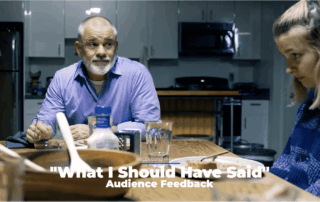 Still from short film depicting a man with a beard looking at a girl who is avoiding his gaze. Both are sitting at a dinner table.